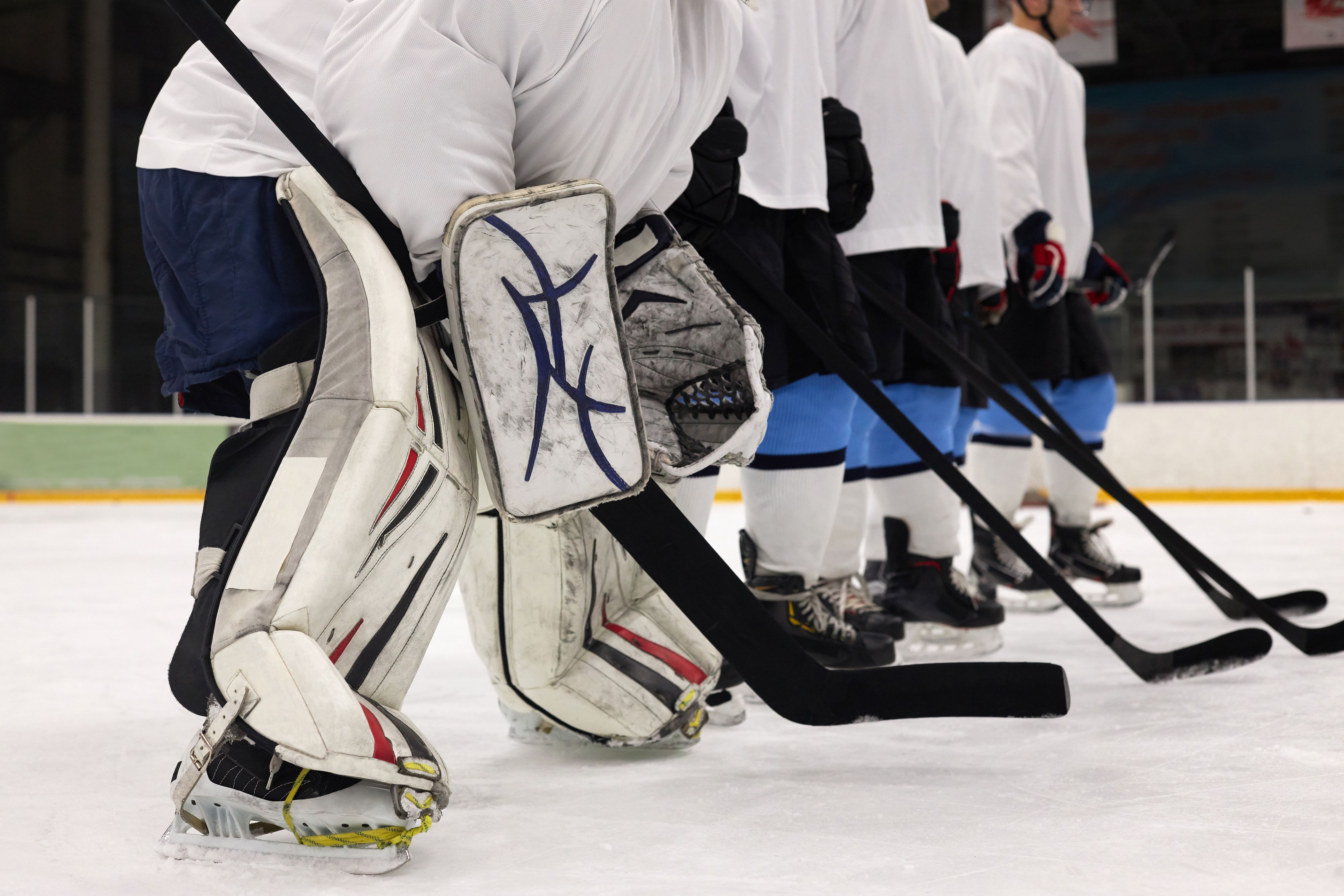 Goaltending equipment lined up on the ice at Elite Goalies Canada training