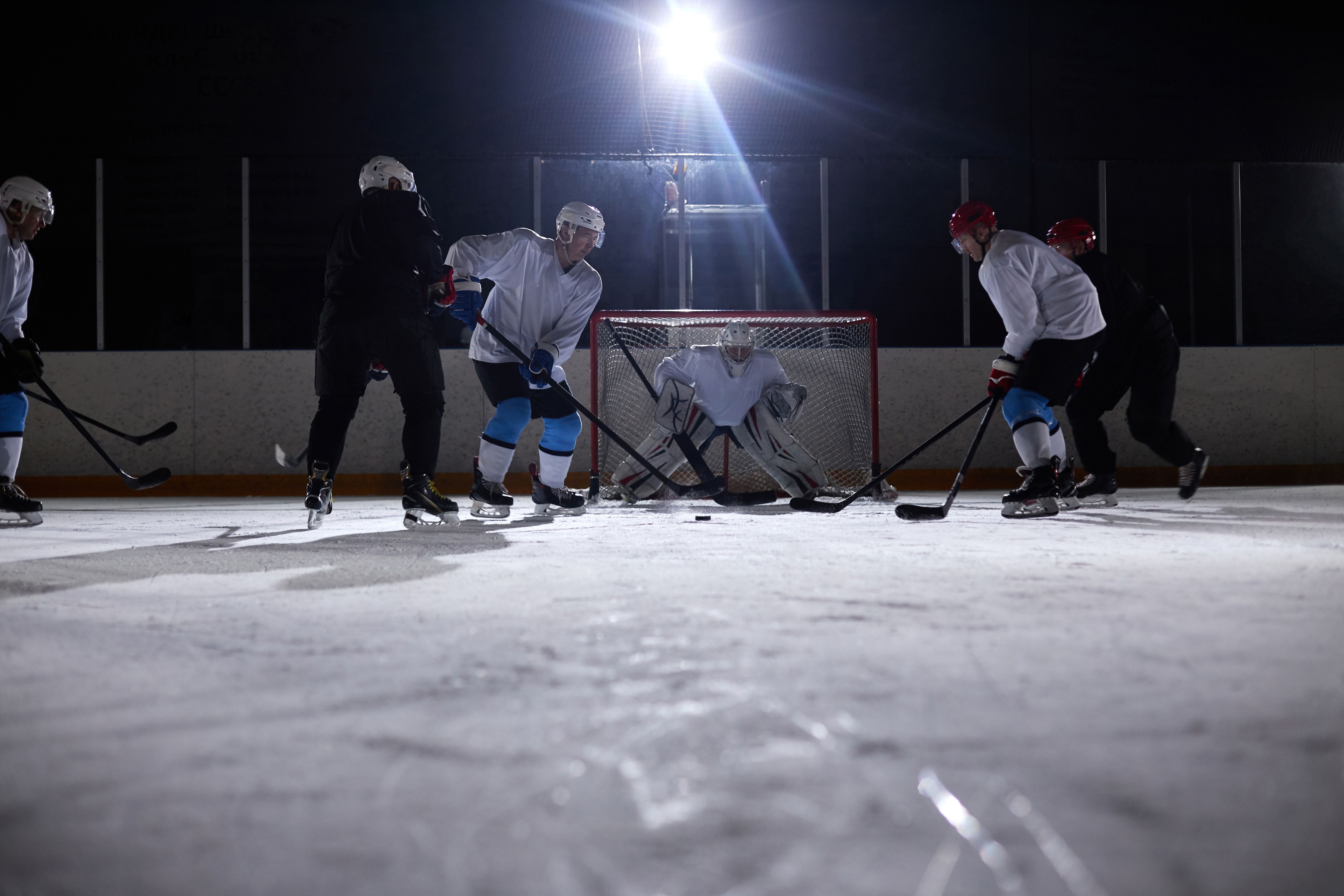 Goaltender receiving focused one-on-one instruction in the crease